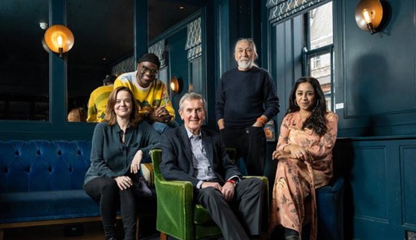 The Booker Prize judges smiling at the camera