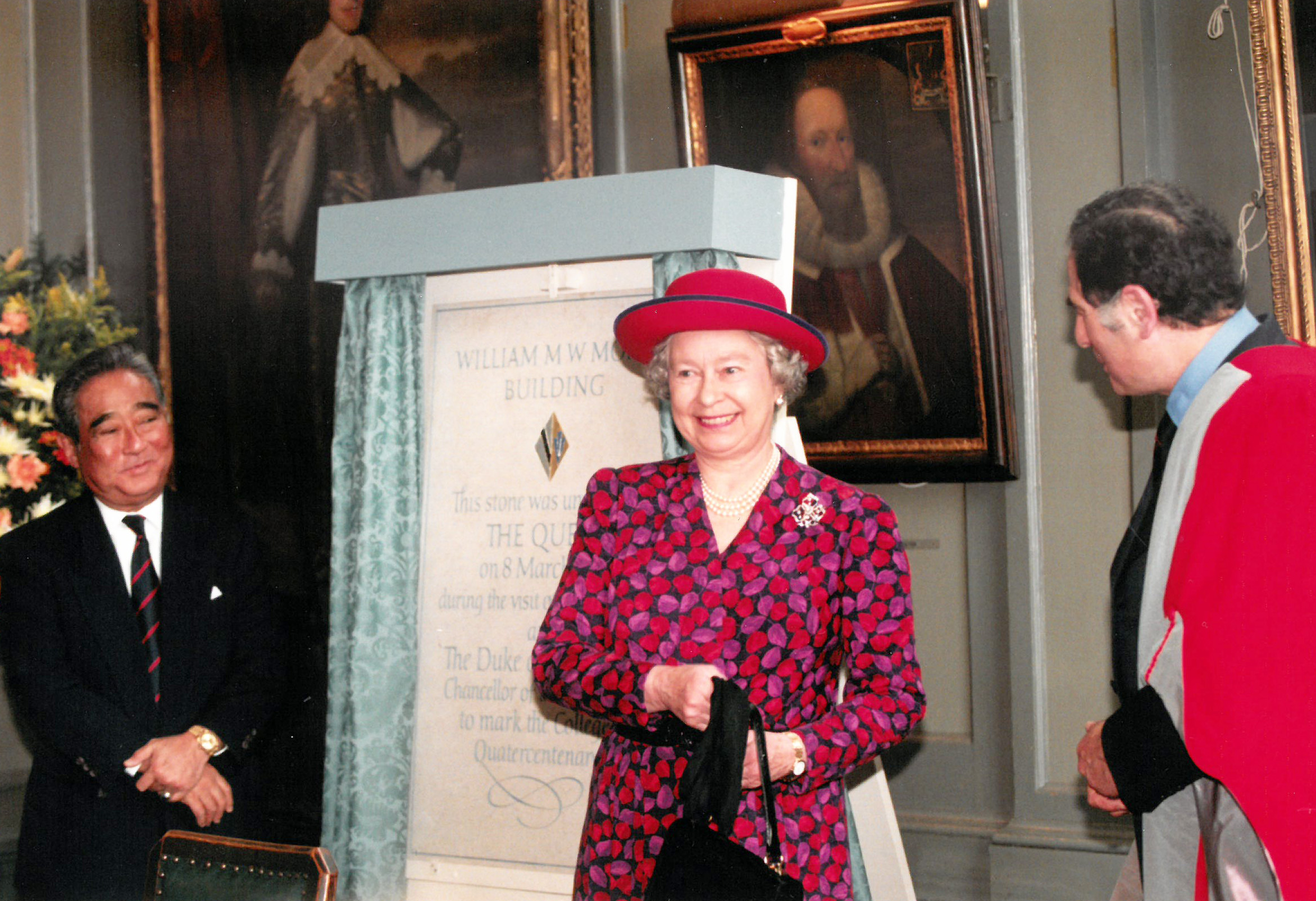 The Queen unveiling of a stone plaque alongside William Mong